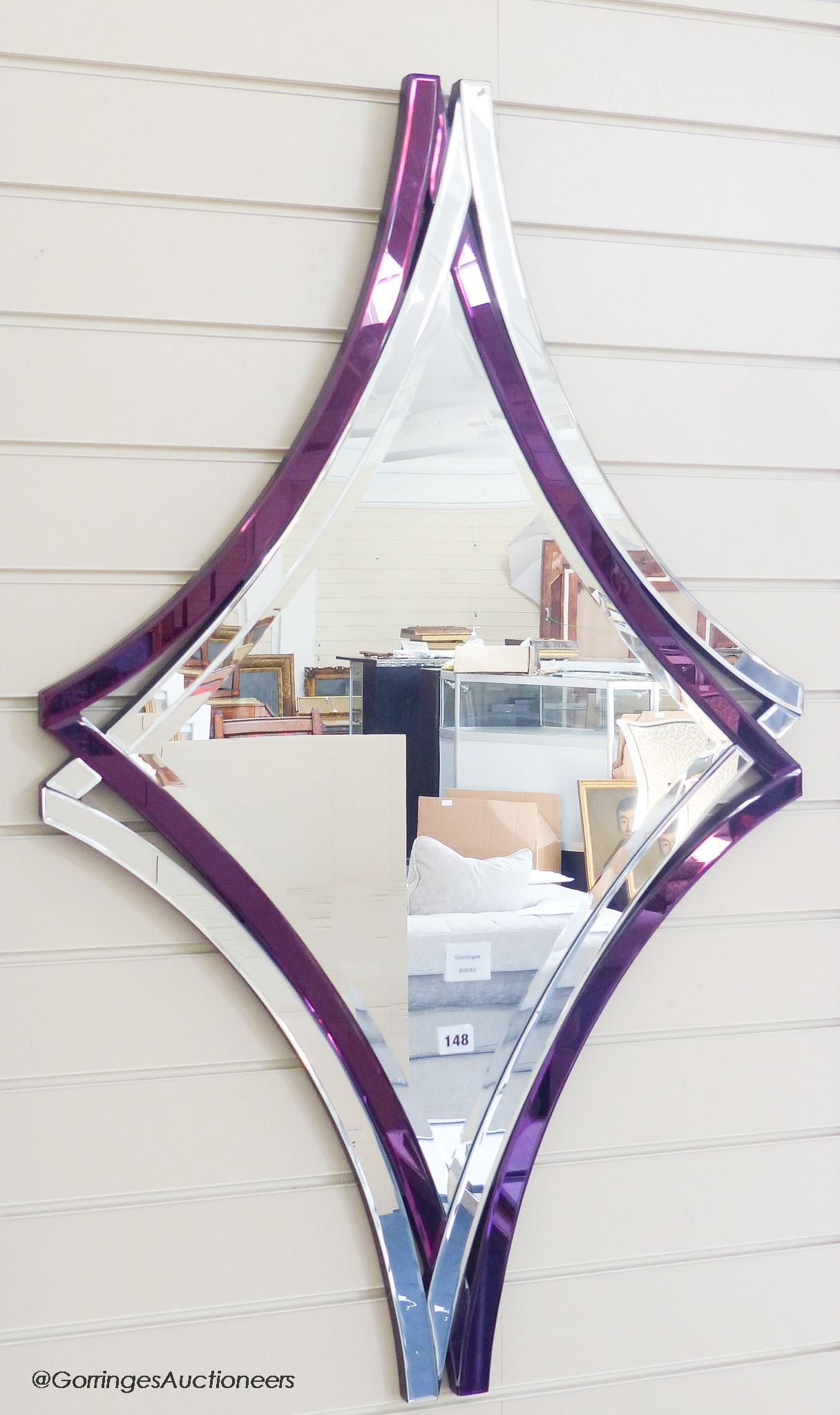 A Deknudt contemporary amethyst tinted mirror, 110 cm x 67.5 cm